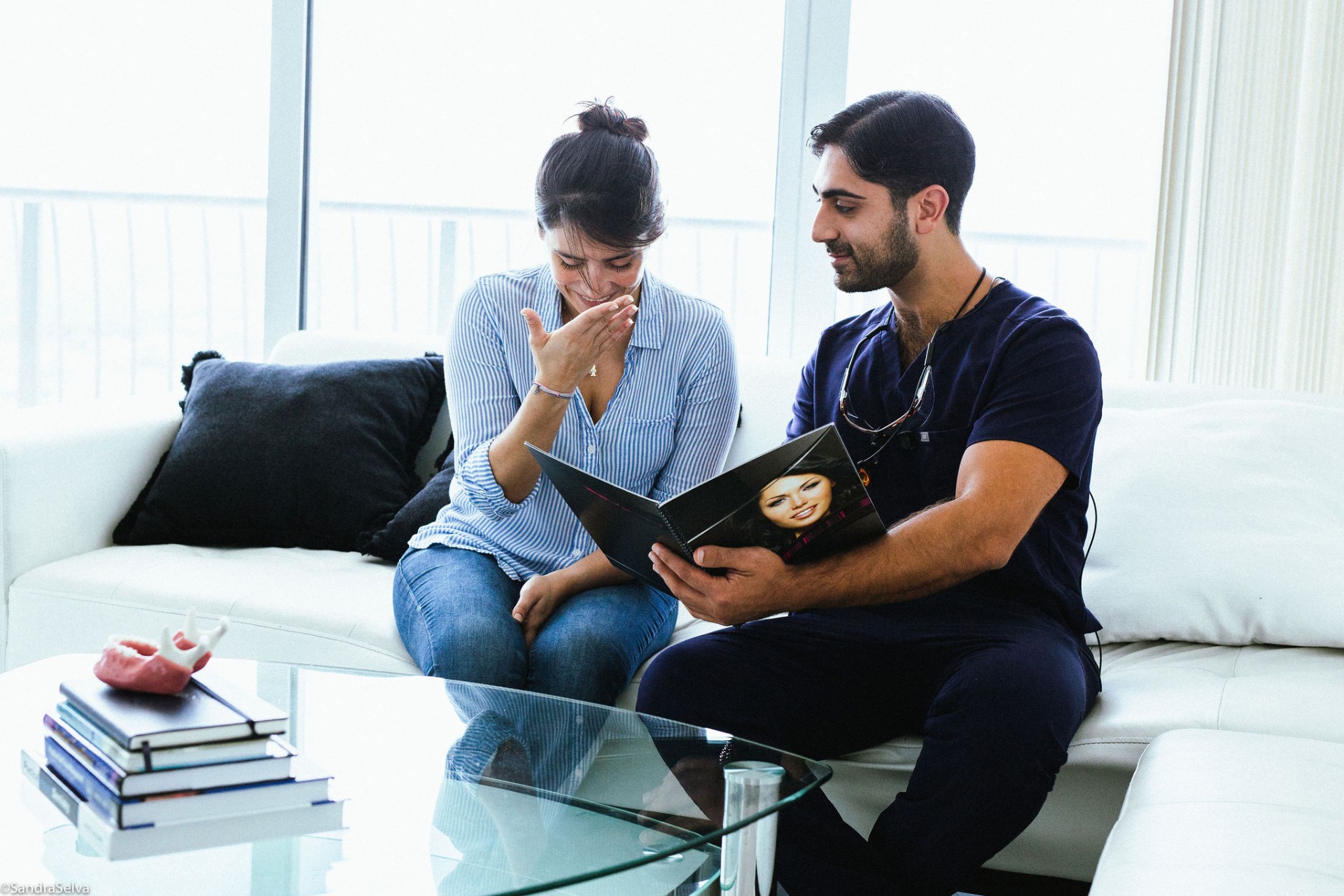 Dr. Allen reviewing a smile design portfolio with a patient